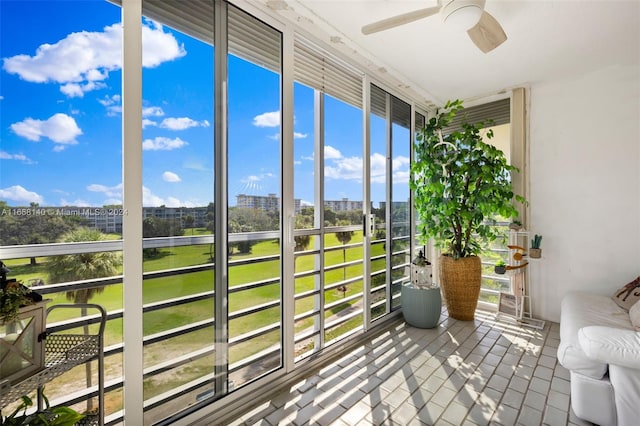 unfurnished sunroom with ceiling fan