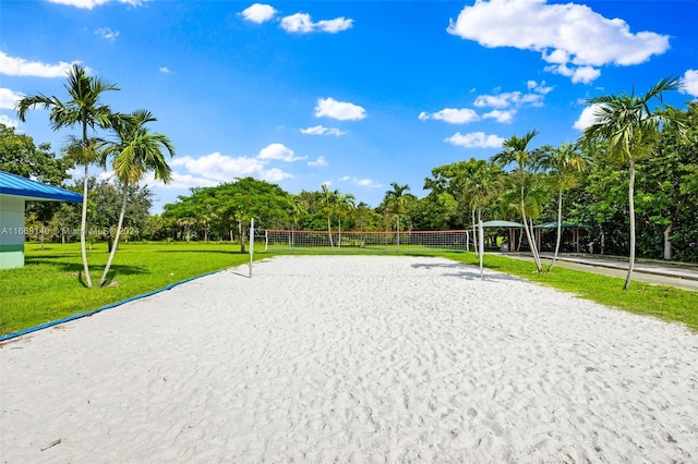 view of property's community featuring a lawn and volleyball court