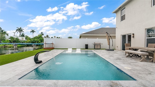 view of yard with a storage unit, a patio, and a water view