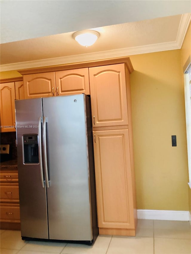 kitchen featuring ornamental molding, light brown cabinets, light tile patterned floors, and stainless steel fridge