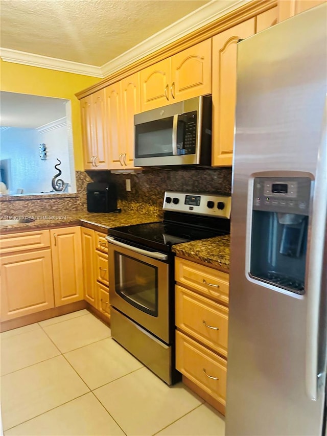 kitchen with stainless steel appliances, backsplash, dark stone countertops, and light brown cabinets