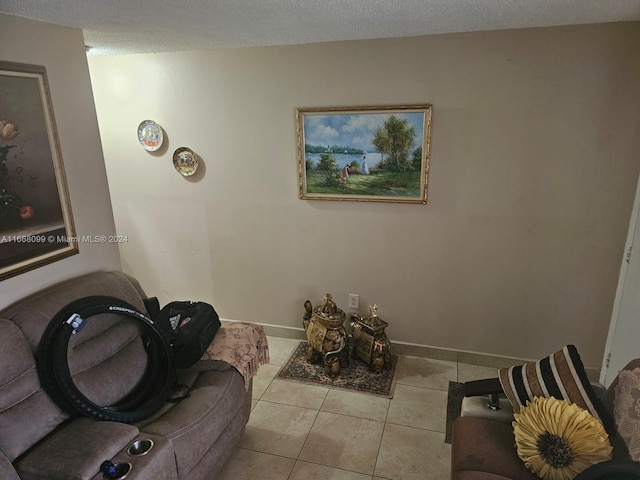 living room featuring a textured ceiling and light tile patterned floors