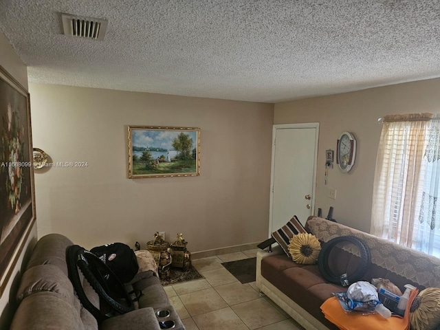 tiled living room with a textured ceiling