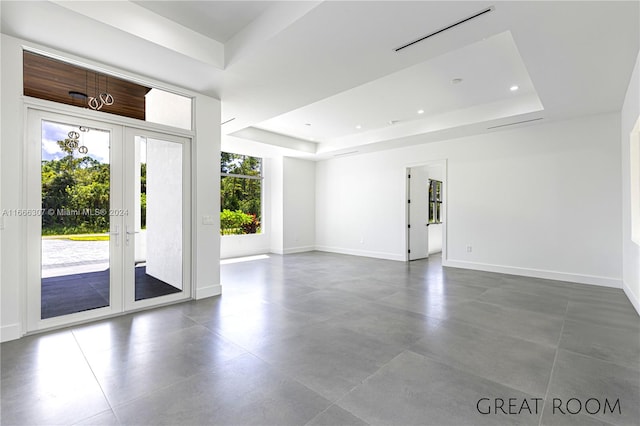 foyer entrance with a raised ceiling