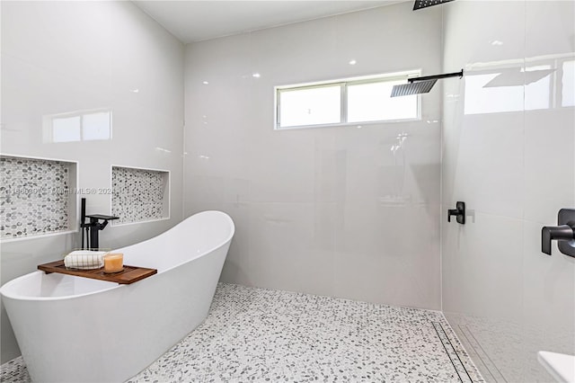 bathroom featuring plus walk in shower