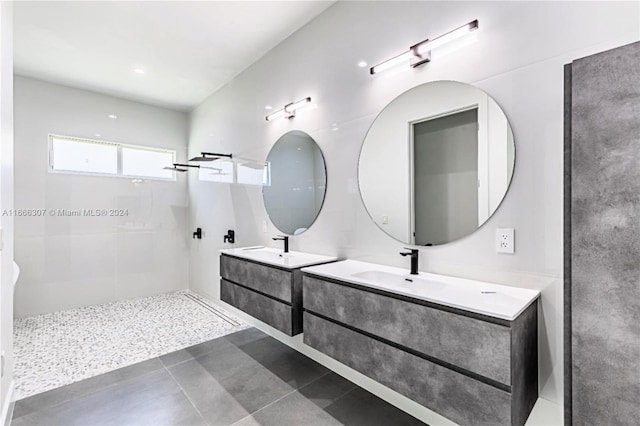 bathroom with vanity and a tile shower