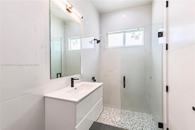 bathroom with vanity and a shower with shower door