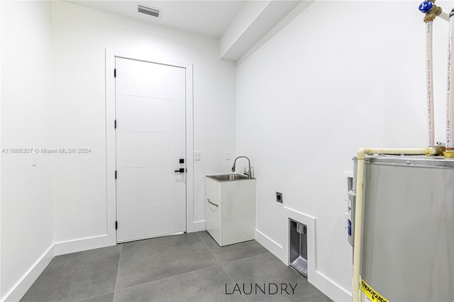 washroom with electric water heater, sink, and electric dryer hookup