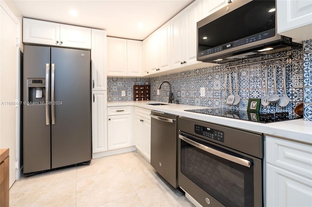 kitchen with white cabinets, stainless steel appliances, and sink