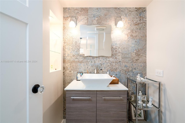 bathroom with tasteful backsplash, vanity, and tile walls