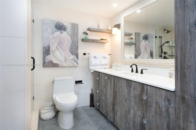 bathroom with tile patterned flooring, vanity, toilet, and an enclosed shower