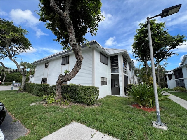 view of side of property with a yard