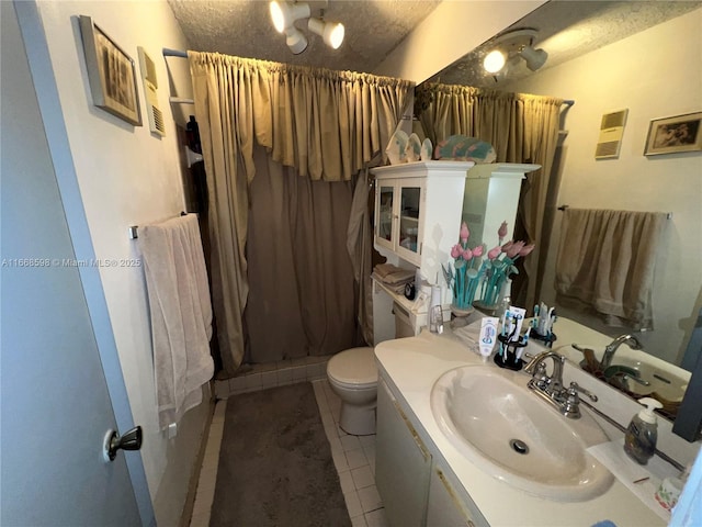 full bathroom with vanity, tile patterned floors, a textured ceiling, toilet, and a shower stall