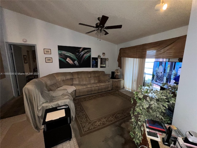 carpeted living room with vaulted ceiling, ceiling fan, and a textured ceiling