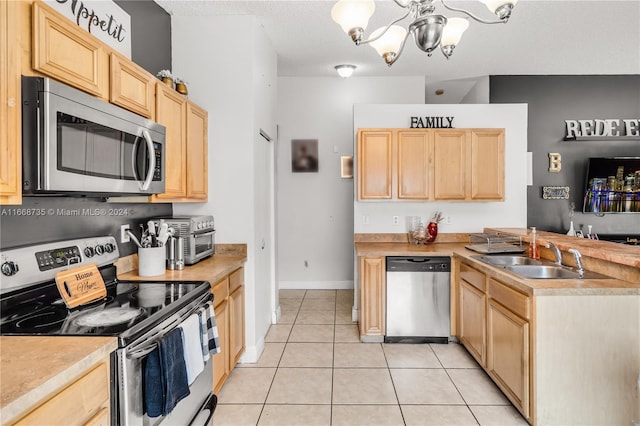 kitchen featuring sink, light tile patterned floors, a chandelier, stainless steel appliances, and light brown cabinetry