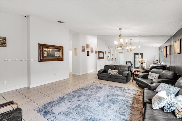 living room with an inviting chandelier, light tile patterned floors, a textured ceiling, and vaulted ceiling