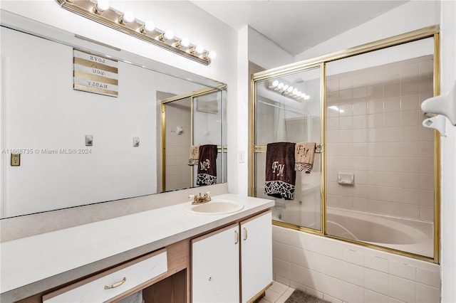 bathroom featuring lofted ceiling, vanity, tile patterned flooring, and enclosed tub / shower combo