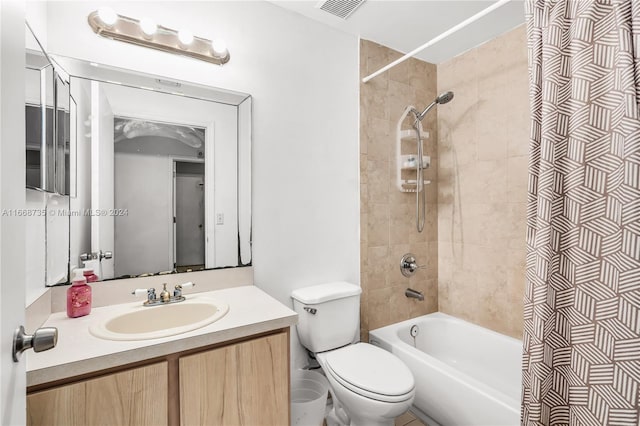 full bathroom with vanity, toilet, and tiled shower / bath