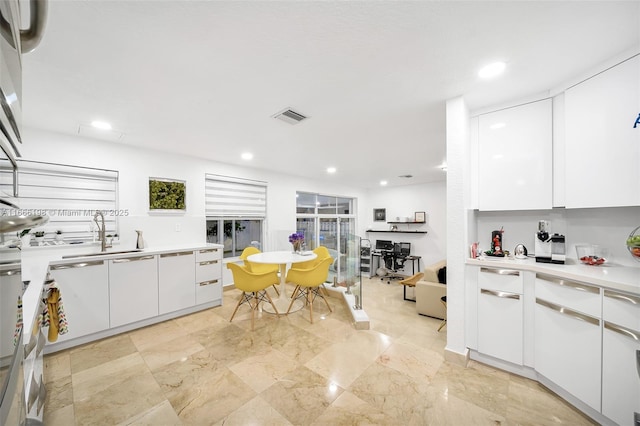 kitchen with visible vents, light countertops, and white cabinetry