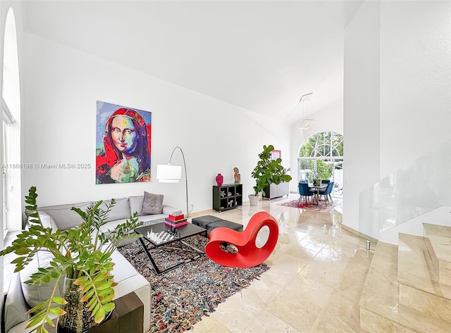 living room with marble finish floor, high vaulted ceiling, and stairs