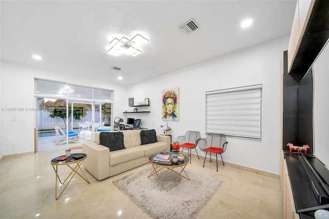 living area featuring recessed lighting, visible vents, and baseboards