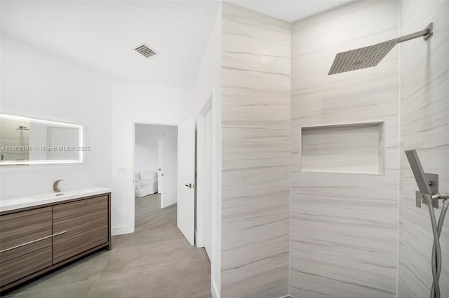 bathroom featuring visible vents, vanity, ensuite bathroom, and tiled shower