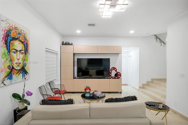 living area featuring stairs, a textured ceiling, visible vents, and recessed lighting