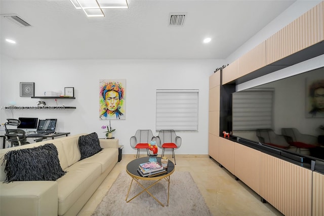 living area with visible vents and recessed lighting