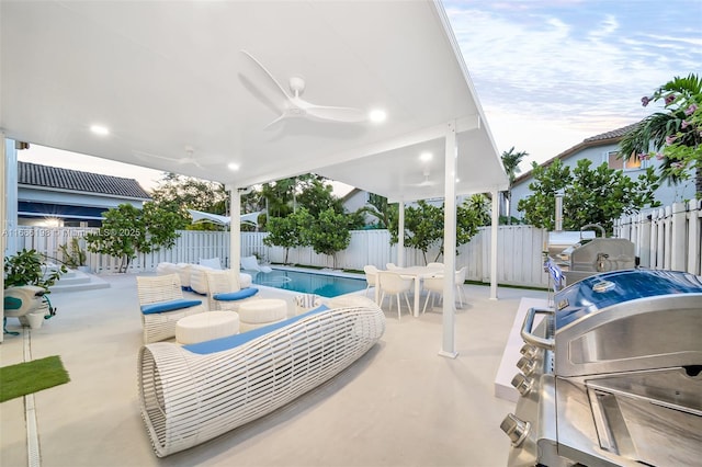 view of patio / terrace with a fenced in pool, outdoor dining area, a fenced backyard, and ceiling fan