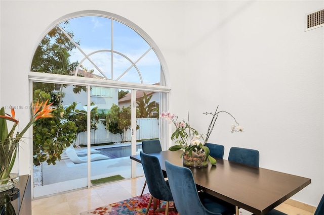 dining space featuring light tile patterned floors and visible vents