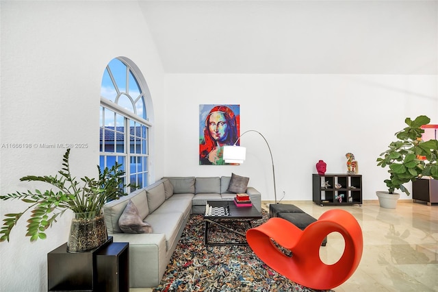 living room with a towering ceiling and marble finish floor