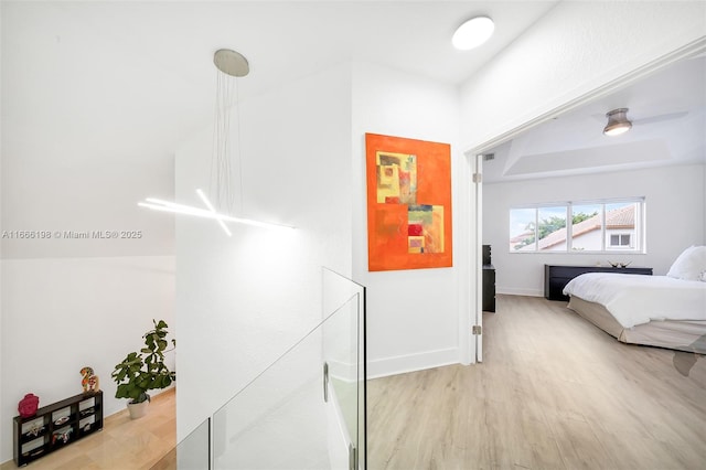 bedroom with baseboards and wood finished floors