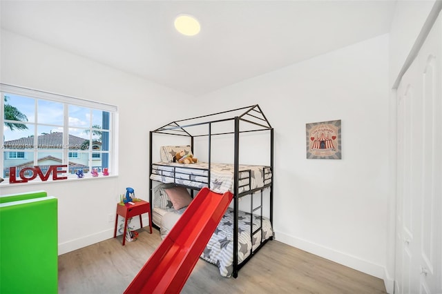 bedroom featuring wood finished floors and baseboards