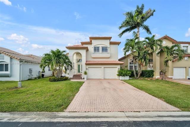 mediterranean / spanish-style house with a front lawn, decorative driveway, an attached garage, and stucco siding