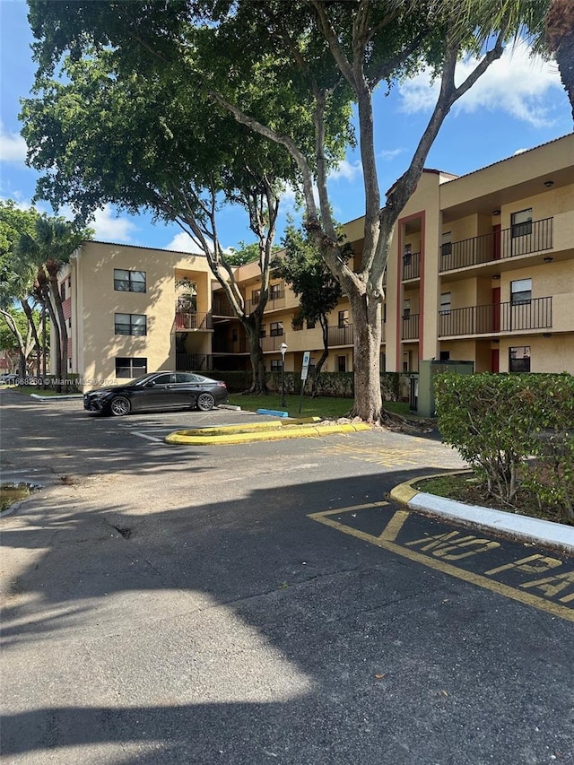 view of building exterior with uncovered parking