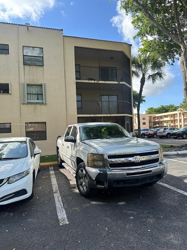 view of property featuring uncovered parking