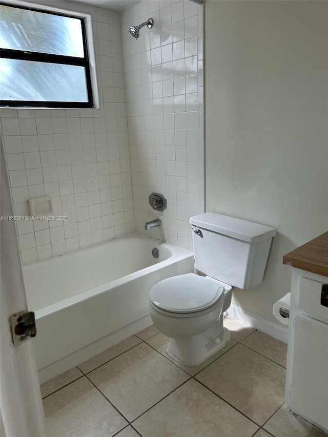 bathroom with tile patterned floors, shower / washtub combination, toilet, and vanity