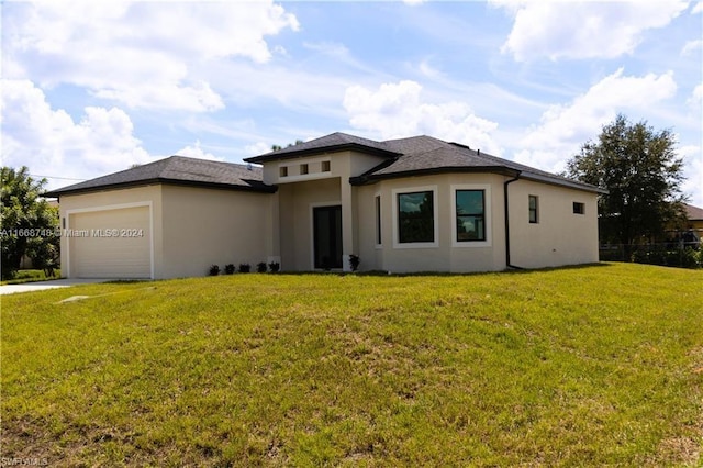 prairie-style home featuring a garage and a front lawn