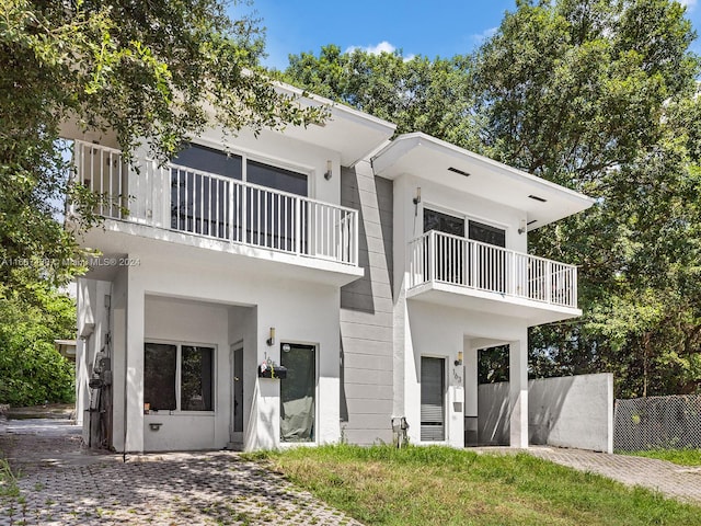 view of front of house featuring a balcony