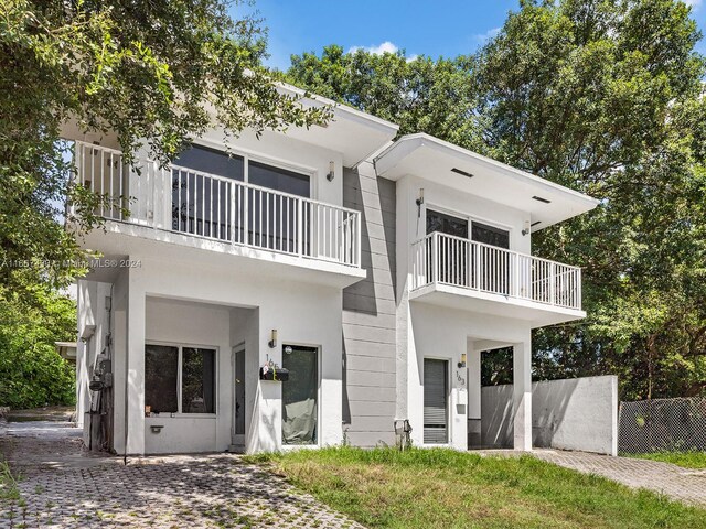 163 NW 68th Ter, Miami, FL 33150 - back of house featuring a balcony and stucco siding