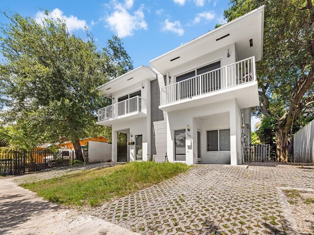 163 NW 68th Ter, Miami, FL 33150 - rear view of house featuring a balcony and stucco siding