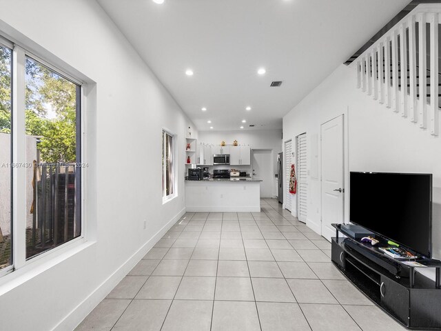 163 NW 68th Ter, Miami, FL 33150 - living area with recessed lighting, light tile patterned floors, and baseboards