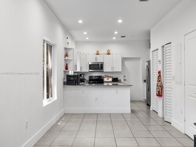 163 NW 68th Ter, Miami, FL 33150 - kitchen featuring stainless steel appliances, recessed lighting, white cabinetry, a peninsula, and baseboards
