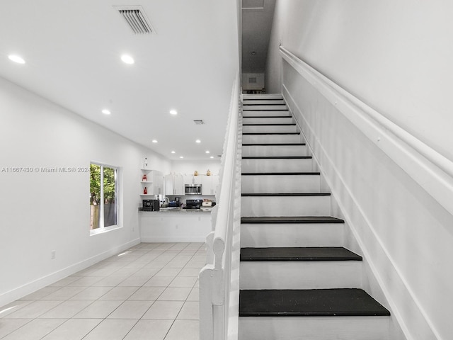 stairs with tile patterned floors