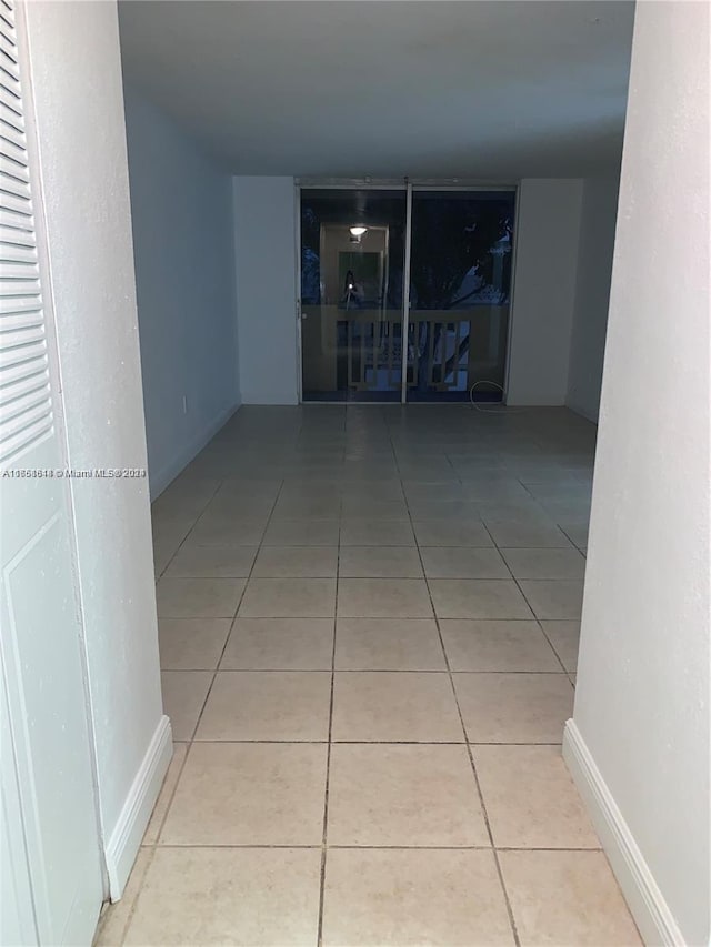 corridor with light tile patterned floors