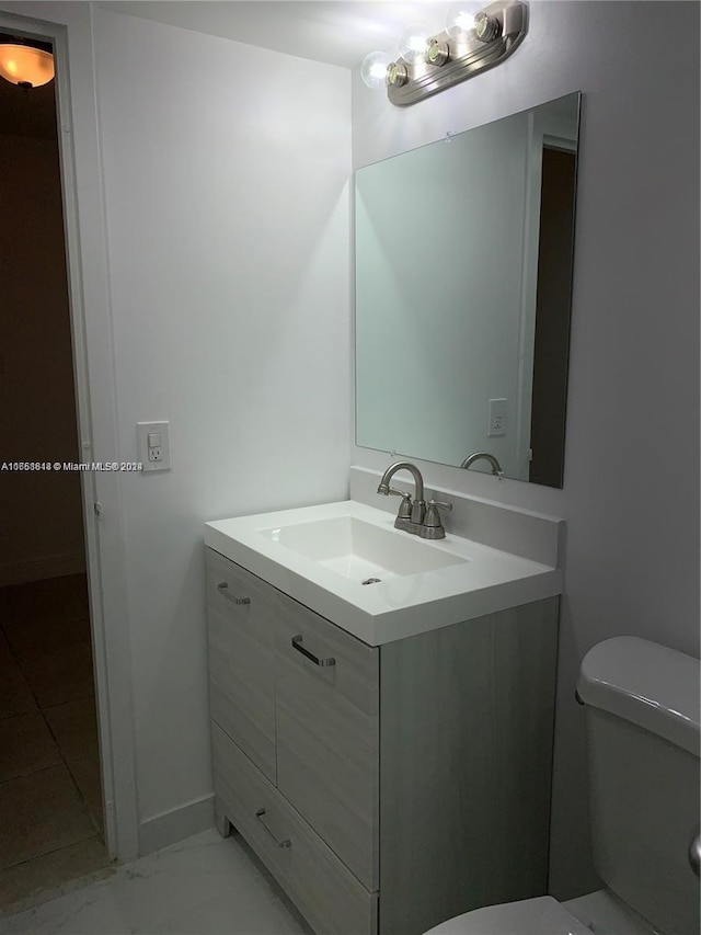 bathroom with vanity and toilet