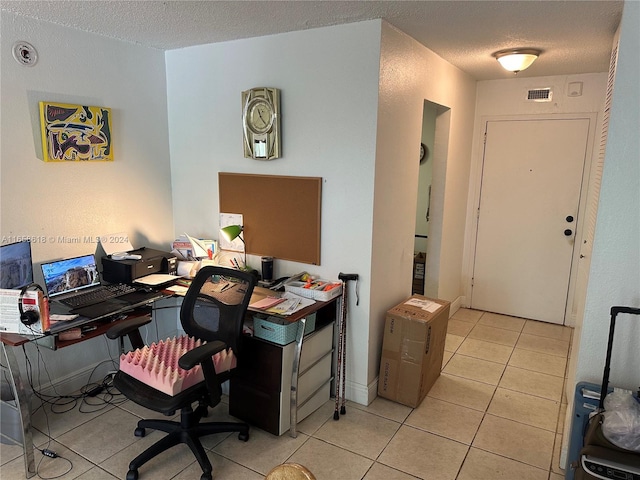 tiled home office with a textured ceiling