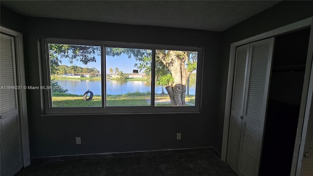 unfurnished bedroom with a water view