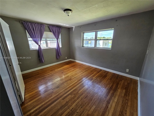 spare room featuring dark hardwood / wood-style floors