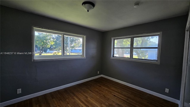 unfurnished room featuring hardwood / wood-style flooring